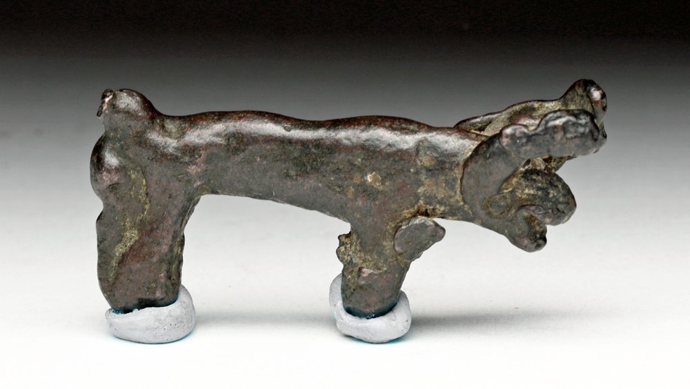 Rare Hittite Bronze Animal Votive: Levant, ca. 1600 to 1400 BCE. Cast bronze animal - probably some form of native ram, with large horns or antlers to the side of the head, mouth open and legs molded together. Beautiful deep brown pati