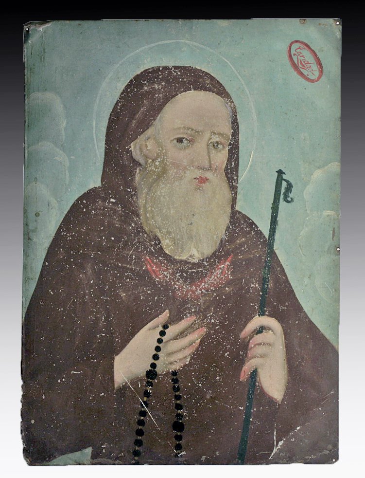 Antique Mexican Retablo - St. Francis of Paola: Mexico, 19th century CE. Beautifully painted retablo on tin with the traditional depiction of San Francisco, the saint associated with charity. Note the word "Caridad is painted at the top right of th