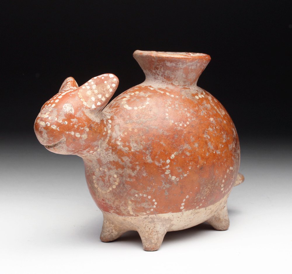 Nayarit Pottery Anamorphic Vessel: Pre-Columbian, West Mexico, Nayarit, ca. 300 BCE to 300 CE. Playful bichrome pottery vessel, animorph in form, perhaps an abstract representation of a coatimundi or a dog. Finished with white painted 