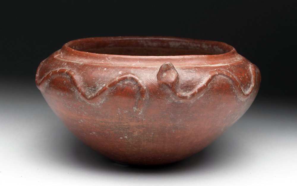 Nayarit Pottery Bowl - Twin Snakes: Pre-Columbian, West coast of Mexico, Nayarit region, ca. 300 BCE to 300 CE. Stunning redware bowl decorated in deep red slip, with two long snakes slithering on the shoulder, their heads raised as if