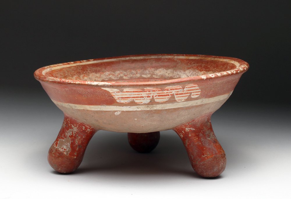 Michoacan Pottery Tripod Grater Rattle Bowl: Pre-Columbian, West Mexico, Michoacan, ca. 1000 CE to 1500 CE. A polychrome tripod grater bowl from the ancient Michoacan culture of West Mexico. Features painted decoration in two shades of red and w