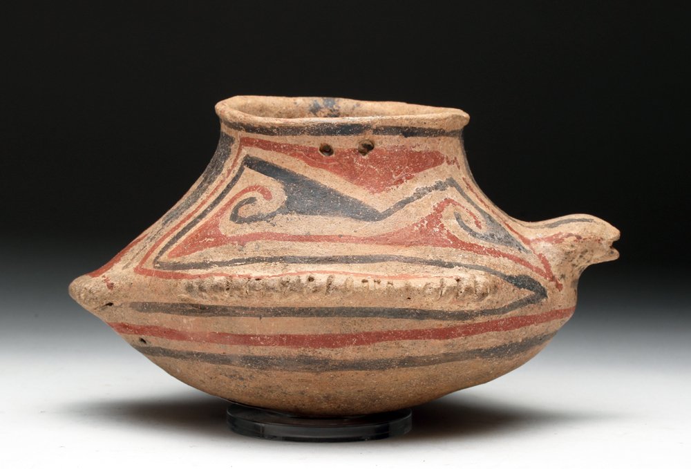 Rare Casas Grande Ramos Polychrome Pottery Bowl: Pre-Columbian, Northern Mexico, ca. 1100 to 1200 CE. Unusual pottery olla in the abstract form of a duck. Painted in red and black over buff, head extending from one side, tail feathers from the oppos