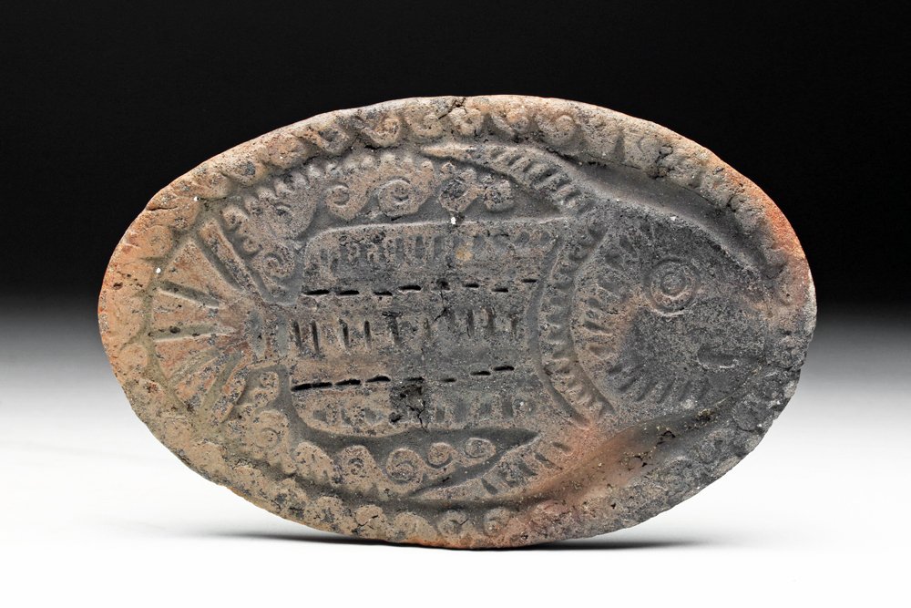 La Tolita Pottery Stamp of Fish: Colombia, La Tolita, Tumaco, ca. 500 BCE to 500 CE. Rare pottery stamp used to decorate textiles and occasionally the human body. Wide platform with well detailed fish and wave patterns around border 