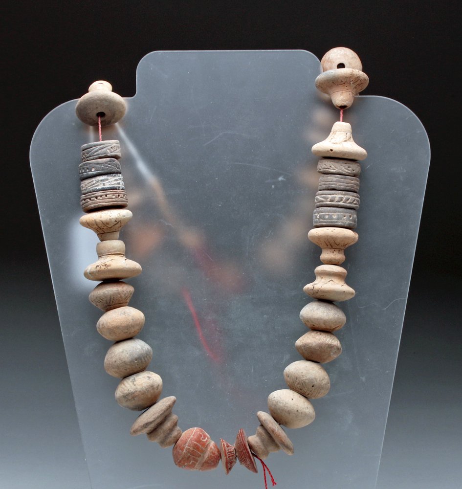 Pre-Columbian Terracotta Spindle Whorls: Pre-Columbian, Western Mexico, Colima, Nayarit or Jalisco, ca. 200 BCE to 200 CE. Large and nicely decorated terracotta spindle whorl strand comprised of 47 individual beads, in several different shap