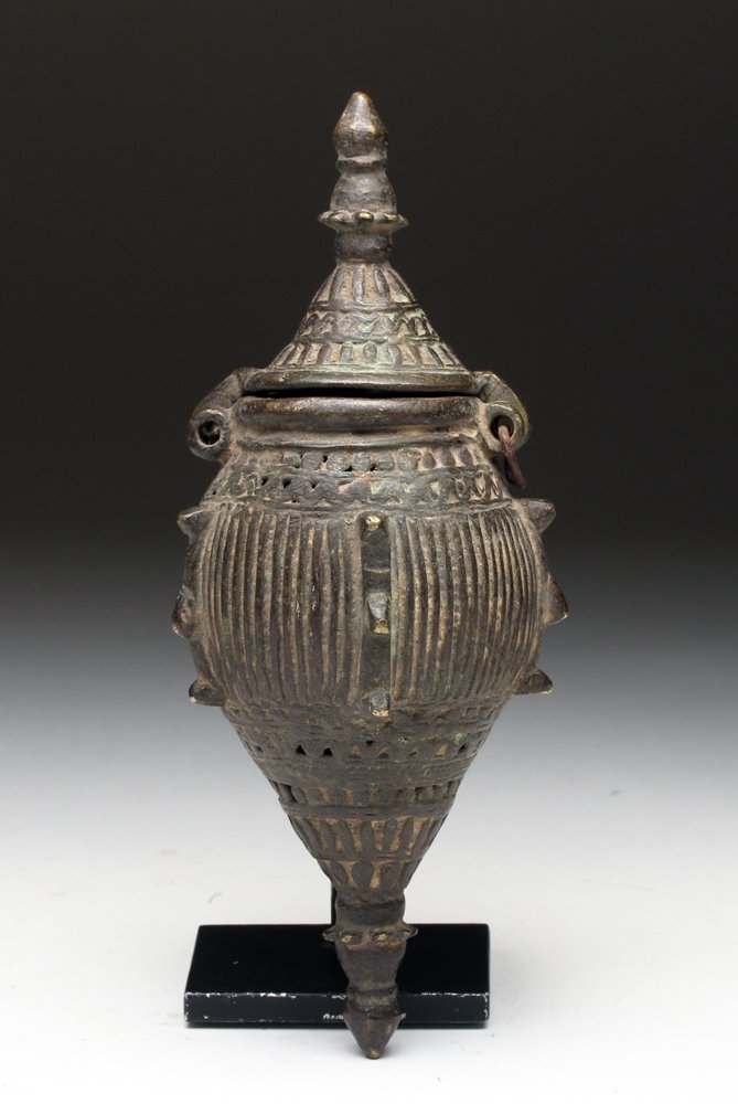 Indian Bronze Cricket Cage - Ornate Decoration: Southeast Asian, India, ca. 1700 to 1800 CE. A bronze cage designed to hold crickets, with an elaborately adorned body of obelisk form, hinged lid with a pagoda-like crest. Crickets were considered go