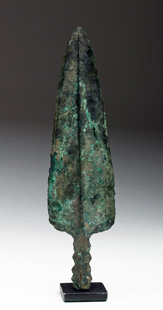 Luristan Bronze Spear Point, Leaf-Shaped: Northwestern Iran, ca. end of 2nd to early 1st millennium BCE. Fine and very sharp ancient spear tip. Leaf shaped blade with central ridge, interesting serrated flange on base. Size: 8-3/4" x 2-1/4". 