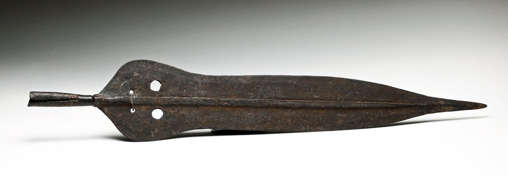 African Kuba Iron Spear Point: Africa, Democratic Republic of Congo, ca. mid 20th century CE. Large and deadly iron spear head with long tapered blade and hollow socket for insertion onto long wooden shaft. Size: 23-3/8" L. Provena