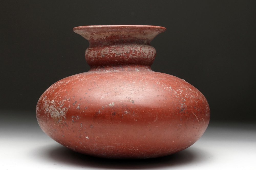 Very Large Redware Olla: Pre-Columbian, Western Mexico, Colima, ca. 300 BCE to 300 CE. Large and lovely redware olla. Bulbous base with two-tiered neck and flared spout. Vessel covered in deep red slip, now with nice deposits