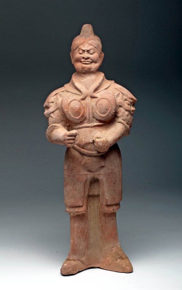 Chinese Tang Dynasty Terracotta Guardian: Asia, China, Tang Dynasty, ca. 606 to 900 CE. Large hollow-molded redware figure of a guardian. He is dressed in layered armor with right hand extended as if to hold a spear, face with deeply fu