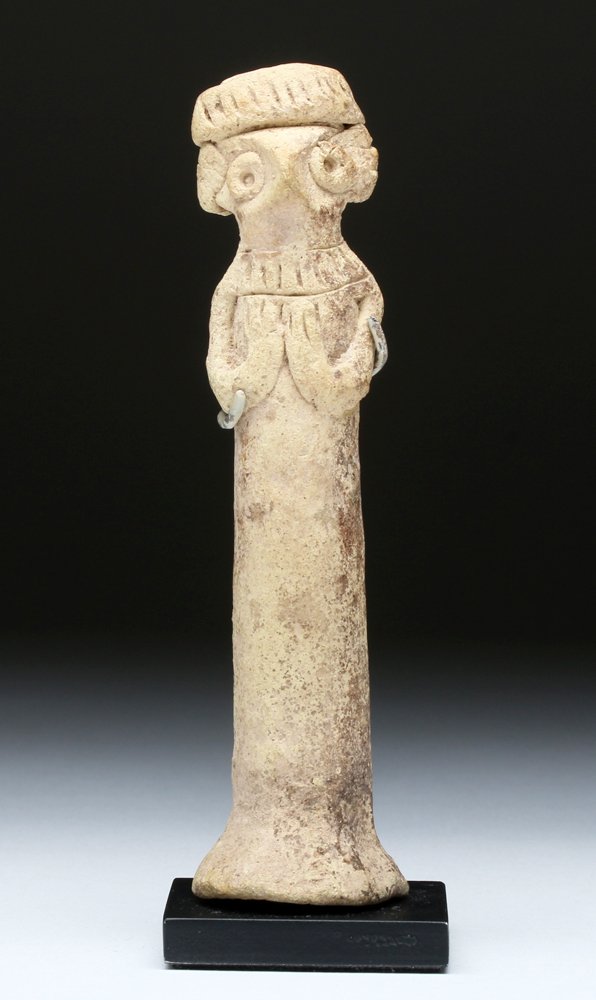 Syro-Hittite Pottery Figurine, Arms on Chest: Ancient Near East, Syria, Syro-Hittite, 2750 BCE to 1900 BCE. An extremely fine Syro-Hittite pillar figurine with mysterious eyes and an almost bird-like presence, yet the monolithic body with hands c