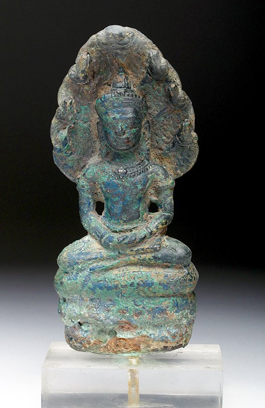 Khmer Seated Bronze Buddha with Naga: Cambodia, Khmer empire, Angkor period, ca. late 11th to early 12th century CE. Seated bronze Buddha, protected by the multi-headed hooded cobra, Naga. He sits with crossed legs, hands to his lap atop 