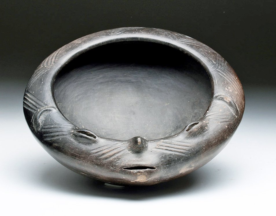 Chupícuaro Human Face Bowl: Central Mexico, Chupícuaro culture, ca. 500 to 300 BCE. The bowl has diagonal hatching on its lip and part of the lip is shaped into a human face with ears, eyes, nose, and mouth. The bowl is covered