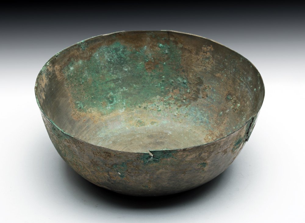 Khmer Cambodian Bronze Bowl: Khmer, Cambodia, ca. 1100 to 1300 CE. This bronze bowl has clear signs of being cast which create a beautiful series of small, barely visible lines throughout the non-patinaed surfaces of the piece. I