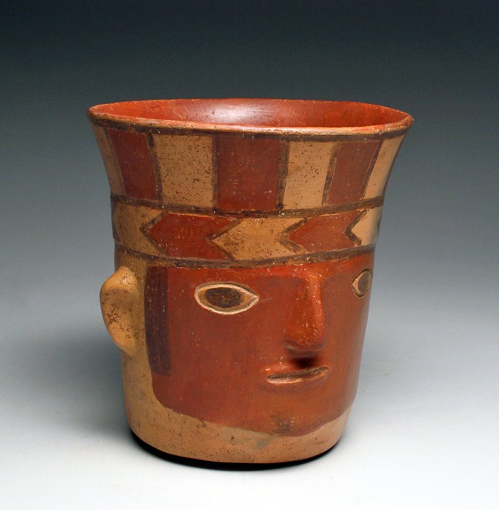 Huari Portrait Syle Face Kero, ex-Hollywood: Pre-Columbian, Southern Peru, Wari / Huari, ca. 700 to 1000 CE. Rare and beautiful masterpiece! Polychrome pottery drinking vessel - mask-like face with prominent nose, hair highlighted in black. Beau