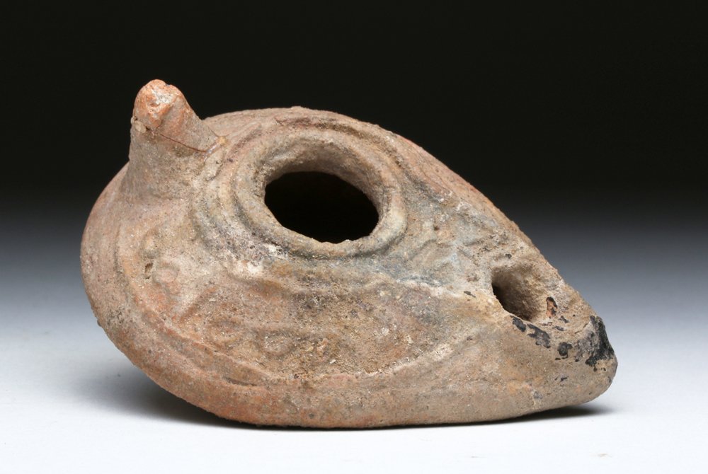 Byzantine Ceramic Oil Lamp - Cross & Inscription: Byzantine, ca. 6th to 7th century CE. An attractive ceramic oil lamp with cross. Ovoid in shape with sharp carination, the shoulders decorated with inscriptions, a raised channel framing the fill hole