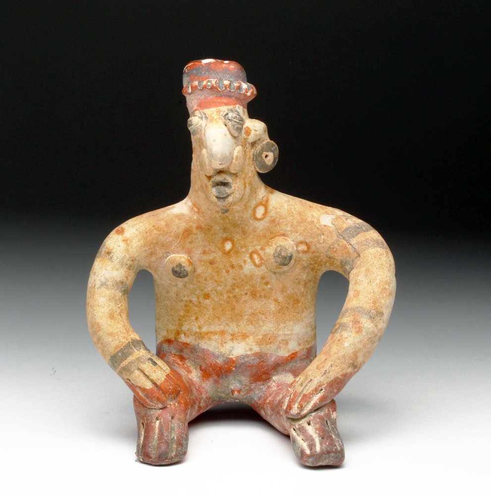 Jalisco Polychrome Pottery Flat: Pre-Columbian, Western Mexico, Jalisco, ca. 300 BCE to 300 CE. Colorful pottery flat of a seated male. He sits with hands to his knees, decorated in added red, black and yellow pigments. Very attracti