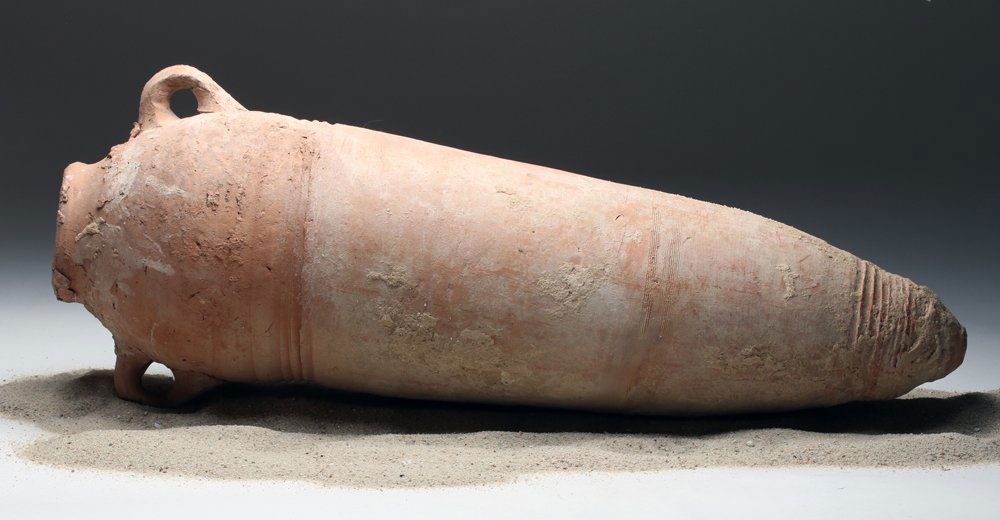 Cypro-Phoenician Torpedo Transport Amphora: Cyprus, Punic / Phoenician rule, ca. 6th to 3rd century BCE. Medium-sized transport amphora used by Phoenician merchants to transport wine, oil and grains. Looking much like the "torpedo" name often g