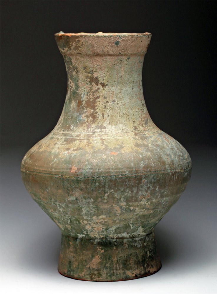 Han Dynasty Green Glazed Pottery Jar / Hu: Chinese, Han Dynasty, ca. 206 BCE to 9 BCE. A large, green glazed red pottery Hu jar of a pear-like shape that continues upwards and resolves to a wide rim and most likely had a lid in its original st