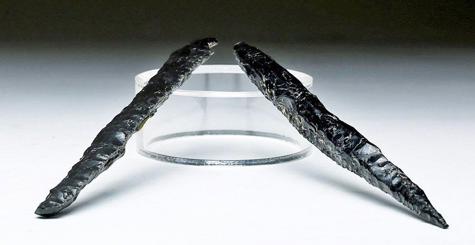 Lot of 2 Colima Obsidian Spear Points: Pre-Columbian, Colima, Mexico, ca. 300 BCE to 300 CE. These are two spear points made from black obsidian that most likely came from eruptions of the Colima volcano. The point of one is still very sha