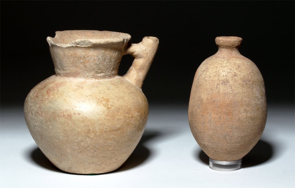 Lot of 2 Holyland Pottery Jars, ex-J. Malter: Holy Land, Iron Age II, ca. 8th to 5th century BCE. This is a set of two bulbous buffware pottery jars that probably would have been used in the household. One has a very narrow neck and small mouth a