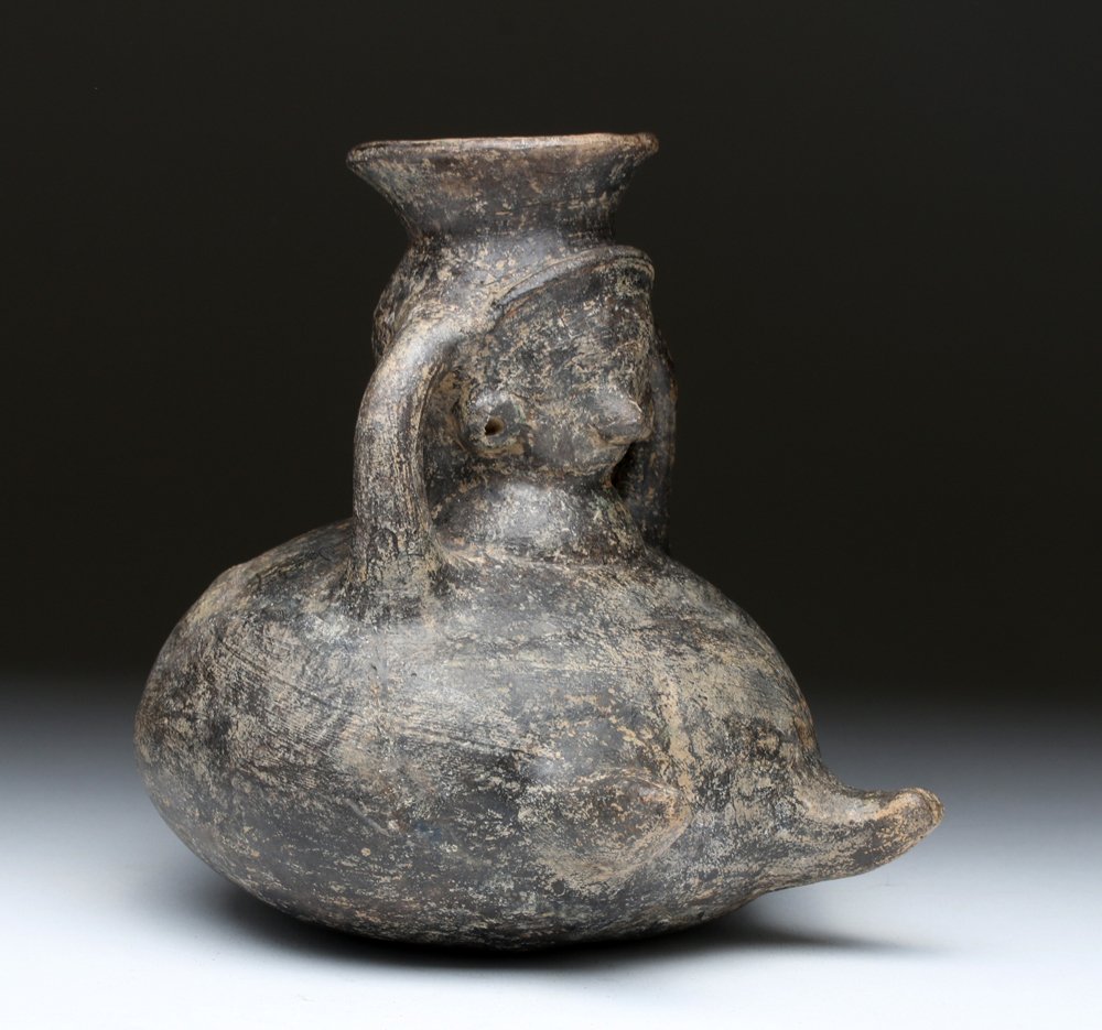Colima Blackware Pottery Figural Jar: Pre-Columbian, West Mexico, Colima, ca. 300 BCE to 300 CE. A blackware olla in the form of a rotund human, this piece has her arms to her head as handles and her legs outstretched; she has simple faci