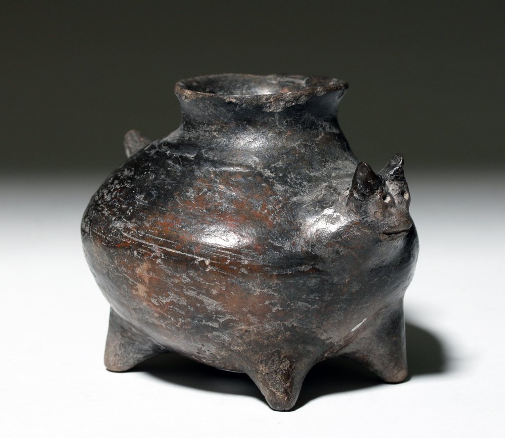 Colima Feline Pottery Jar: Pre-Columbian, West Mexico, Colima, ca. 300 BCE to 300 CE. This is a narrow necked, round-bodied four-legged jar with feline head, tail, and legs -- a "fat cat" olla. Size: 4-1/2" W x 4" L x 3-1/2" H 