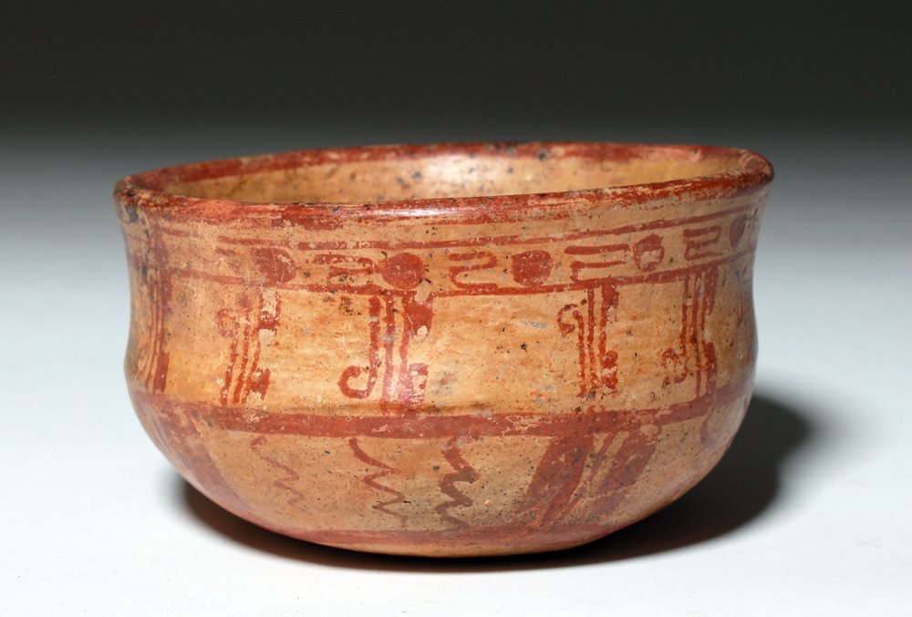 Mayan Bichrome Terracotta Bowl: Pre-Columbian, Mayan, ca. 550 to 900 CE. Finely decorated Mayan bowl with slightly concave shoulder. Bowl is decorated with waves, bands, and other geometric patterns in red over cream. Areas of exter