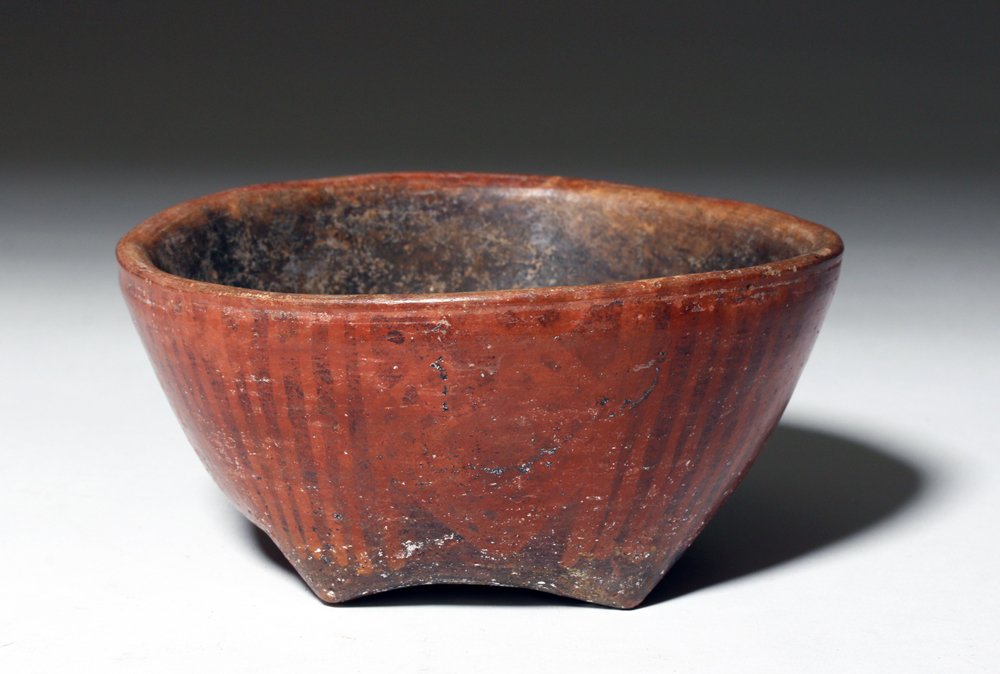 Colombian Narino Negative Resist Pottery Bowl: Pre-Columbian, Colombia, ca. 850 to 1500 CE. An attractive hand built dark clay bowl that stands upon four pinched feet and is beautifully decorated with negative resist in geometric patterns. Size: 5