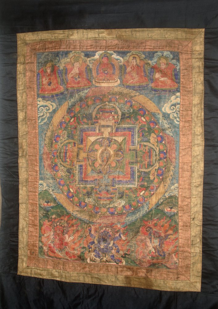 16th C. Buddhist Thangka - Mandala Circle: Nepal or Tibet, ca. 1500 to 1600 CE. This is a painting of a mandala with a linen cover. The same symbol is inscribed eight times in red on the back of the painting, five times along the top and three