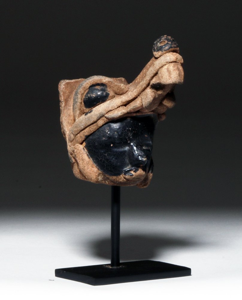 Veracruz Warrior with Coyote Headdress: Pre-Columbian, Mexico, Vera Cruz, ca. 200 to 500 CE. This is the pottery head of a person with their face painted black wearing a coyote head mask; the piece has a hollow neck and was clearly removed 