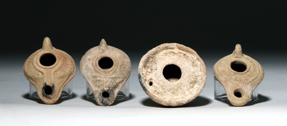 Lot of 4 Byzantine / Holy Land Oil Lamps, ex-J. Malter: From the ancient Near East, Holyland / Byzantine Empire, ca. 5th to 8th century CE. This group of four oil lamps make a nice complementary collection with a range of styles and decoration. None have a