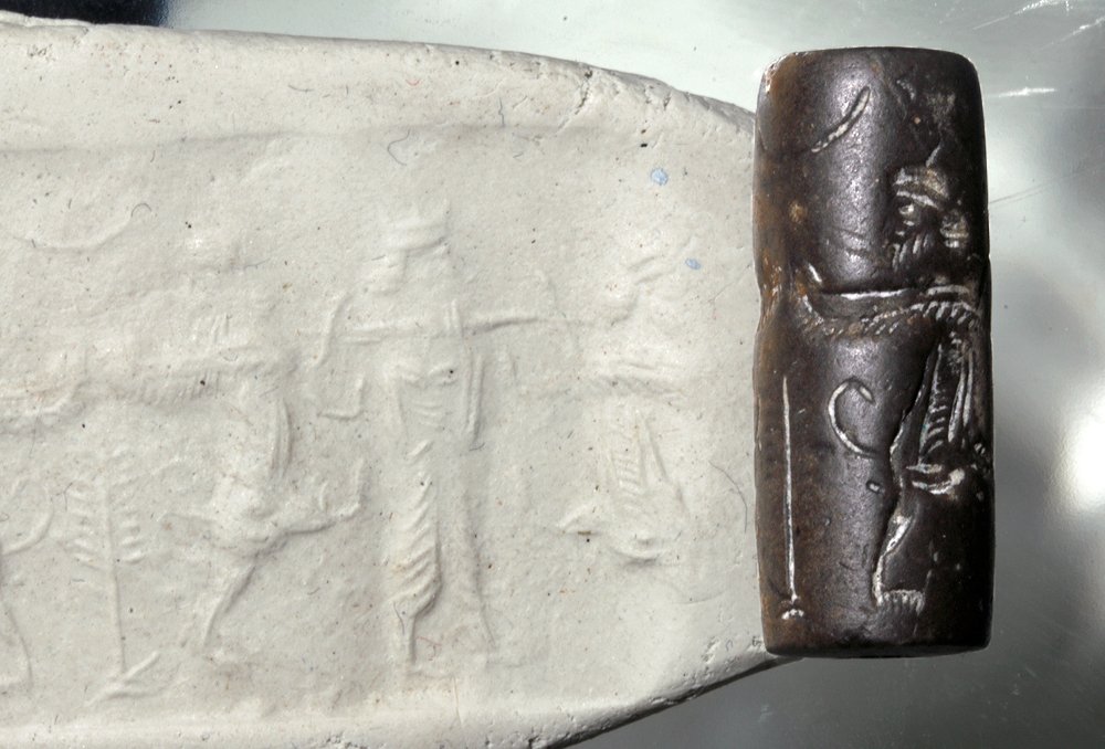 Neo-Babylonian Steatite Cylinder Seal: Ancient Near East, Neo-Babylonian, ca. 1000 to 539 BCE. This is a very interesting steatite (soapstone) cylinder seal depicting a man with traditional hair and beard style familiar from Babylonian art