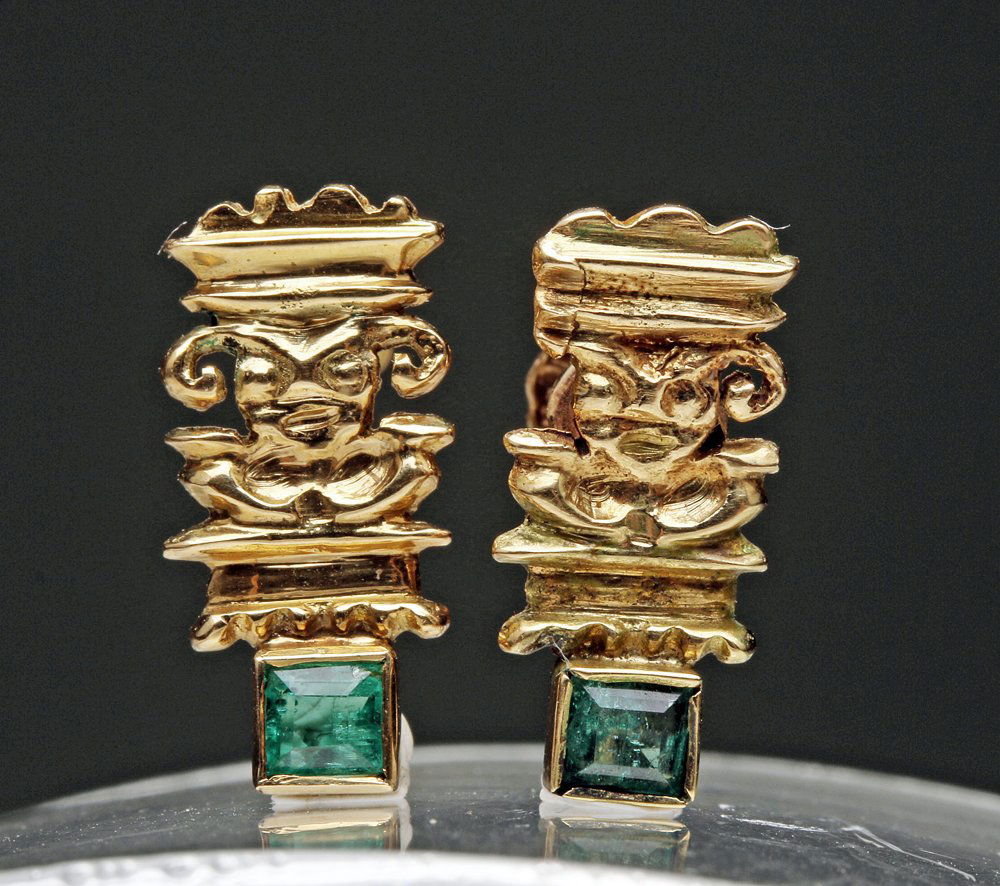 Moche-Inspired Gold Earrings w/ Emeralds - Ai Apec: Moche inspired, modern. A pair of 16K gold and emerald screw-back earrings, each featuring a depiction of the Moche god Ai Apec, standing atop an emerald-cut emerald. Size: 3.2 grams; each measures 5/