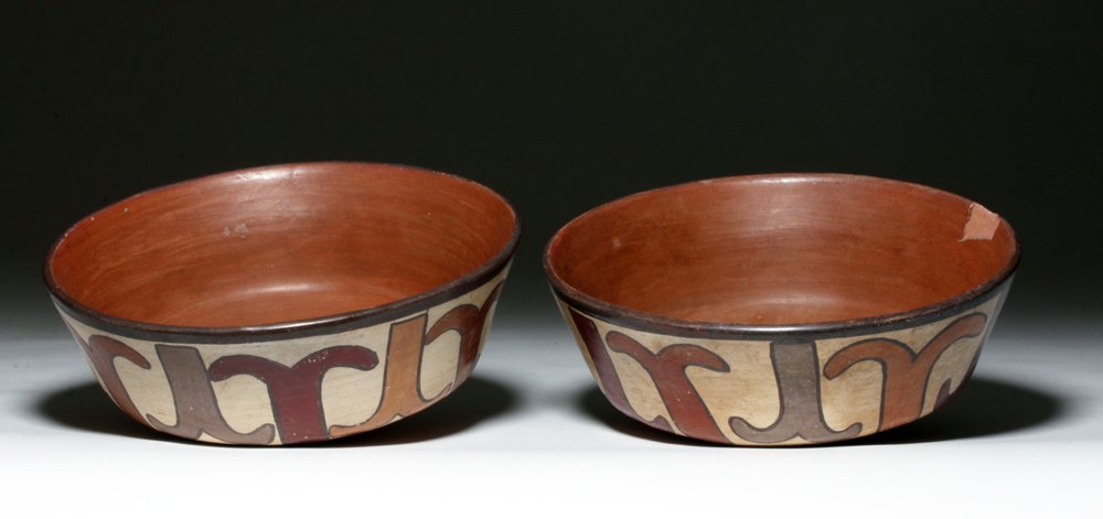 Gorgeous Matched Pair Nazca Polychrome Bowls: Pre-Columbian, Nazca culture, modern-day Peru, ca. 200 CE. This is a pair of polychrome bowls with a design that reminds us at the office of either whale tails or two fish hooks back to back. The tran