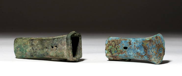 Ancient Bronze Axe Heads - Warring States + Dong Son: Southeast Asia, Viet Nam, Dong Son culture, ca. 500 to 300 BCE. A cast bronze axe head with a crescent moon shaped blade and an open socket with two perforations for mounting on wooden shaft. Boasts