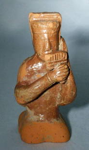 Chinese Han Dynasty Glazed Figure of Musician: Far East, China, Han Dynasty, ca. 206 BCE to 220 CE. A charming depiction of an ancient Chinese pan flute player with partial brown glaze over natural terracotta made during the Han Dynasty. Forms