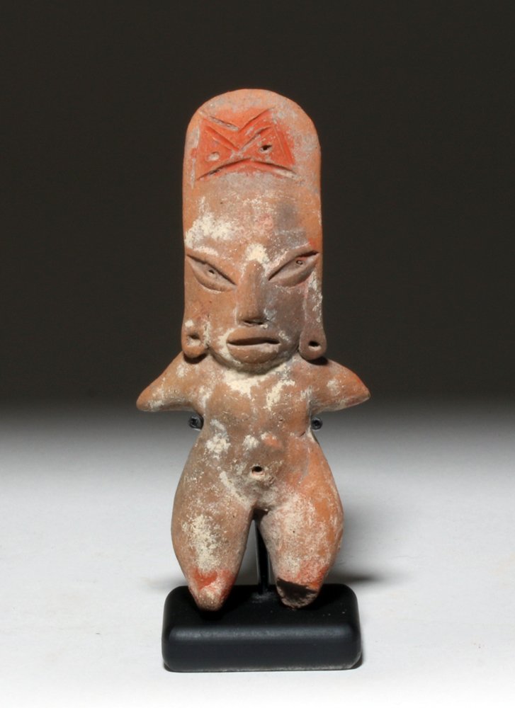 Pre-Columbian Morales Pottery Standing Figure: Pre-Columbian, Mexico, ca. 1500 to 700 BCE. Rare pre-Classic pottery figure contemporary with the Olmec. Standing female flat, arms to her sides and pointed legs shown nude save decorated headdress. A