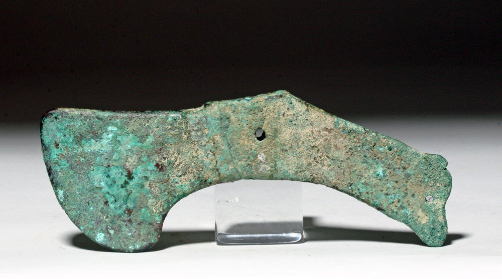 Bactrian Bronze Socketed Axe Head, ex-Piscopo: Bactria-Margiana, modern day central Asia, ca. 3rd to 2nd millennium BCE. This is a bronze axe head with a characteristic curved shape and narrow socket. There is distinctive flaired shapes on both en
