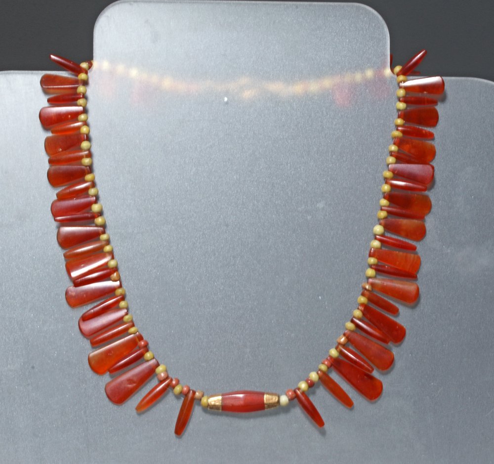 Bactrian / Roman Necklace - Carnelian, Glass, Gold: Late Bactrian to very early Roman periods, western Asia, ca. 300 BCE to 100 CE. Incredible necklace comprised of carnelian pendants in deep orange to red paddle-shapes interspersed with yellow glass p