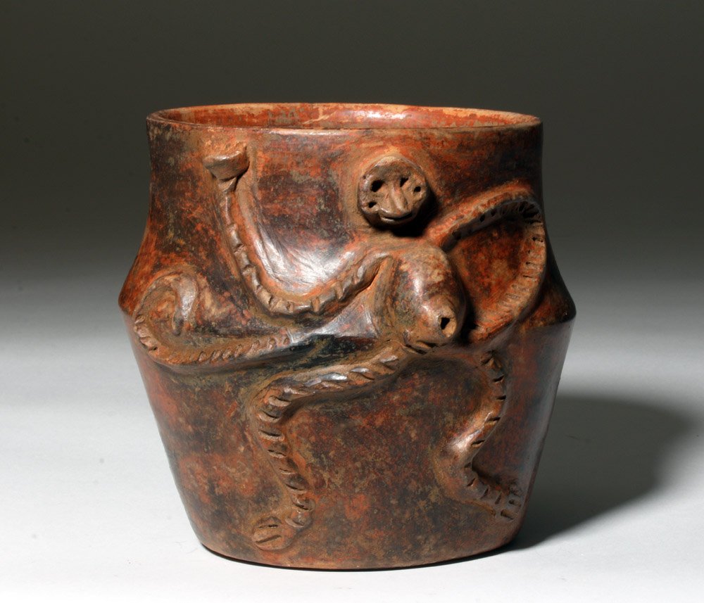 Mayan Redware Monkey Cylinder, ex-Arnovick: Pre-Columbian, Mexico or Guatemala, Mayan, ca. 550 to 900 CE. A hand-built, nicely burnished redware vessel, of an attractive form with a body that gracefully bows outward at the midline, the surface