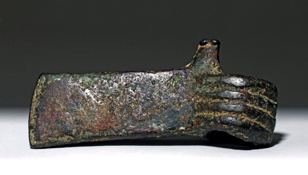 Hittite Bronze Axehead w/ Decorated Socket, ex-Piscopo: Ancient Near East, Syria or Turkey, Hittite, ca. 1100 to 700 BCE. This is a large cast bronze axe head with a linear design on its socket that gives the impression of coiled loops. Decorated axe heads
