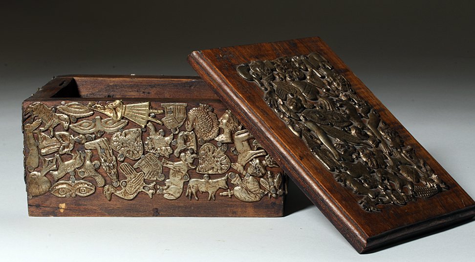 19th C. Mexican Wood Box Covered in Antique Milagros: Mexico, 19th to early 20th century. Delightful stained pine box covered on 5 sides with almost every shape and type of tin milagro. Depicted are birds, heads, praying figures, cows, torsos, feathers, 