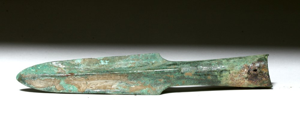 Chinese Warring States Bronze Spearhead, ex-Piscopo: China, Warring States Period, 475 to 221 BCE. This is a small, finely shaped socketed bronze spearhead with a socketed tip and a tiny loop for affixing some perishable item. The piece has incredibly p