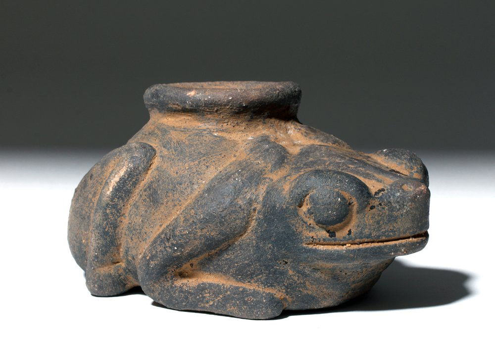 Pre-Columbian Blackware Central American Frog / Toad: Pre-Columbian, Central America, culture unknown, ca. 900 to 1400 CE. A blackware pottery vessel in the shape of a plump frog (rana in Spanish) or toad (sapo in Spanish) with a wide rim upon its back.