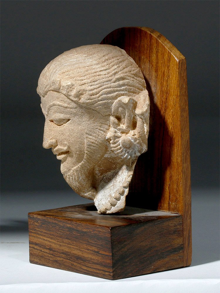 Rare 11th C. Indian Stone Ecstatic Head - Khajuraho: Central Asia, India, Madhya Pradesh, ca. 8th to 10th century CE. A finely carved terracotta head from the Khajuraho monuments, temples known for their nagara style architectural symbolism and their ex