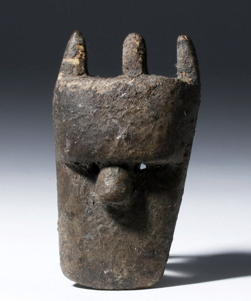 Liberia Loma Wood Maskette: Liberia, Loma people, early 20th century CE. This hand carved, wooden mask has a simple but effective design that uses very few lines to show a broad forehead, heavy brows, and a thick nose; there is