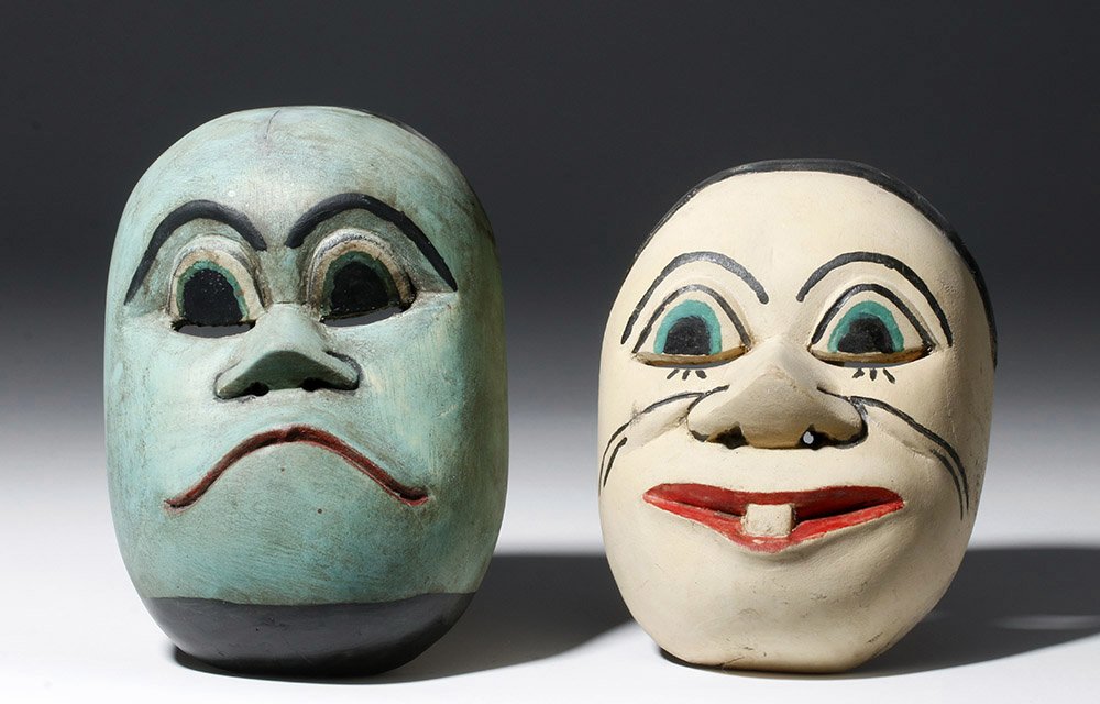 Pair of Indonesian Masks in Topeng Style: Indonesia, Bali or Java, 20th century CE. This is a pair of hand carved wooden masks in the style of Topeng. One is painted blue with serious, downturned lips and wide eyes; the other is a creamy whit