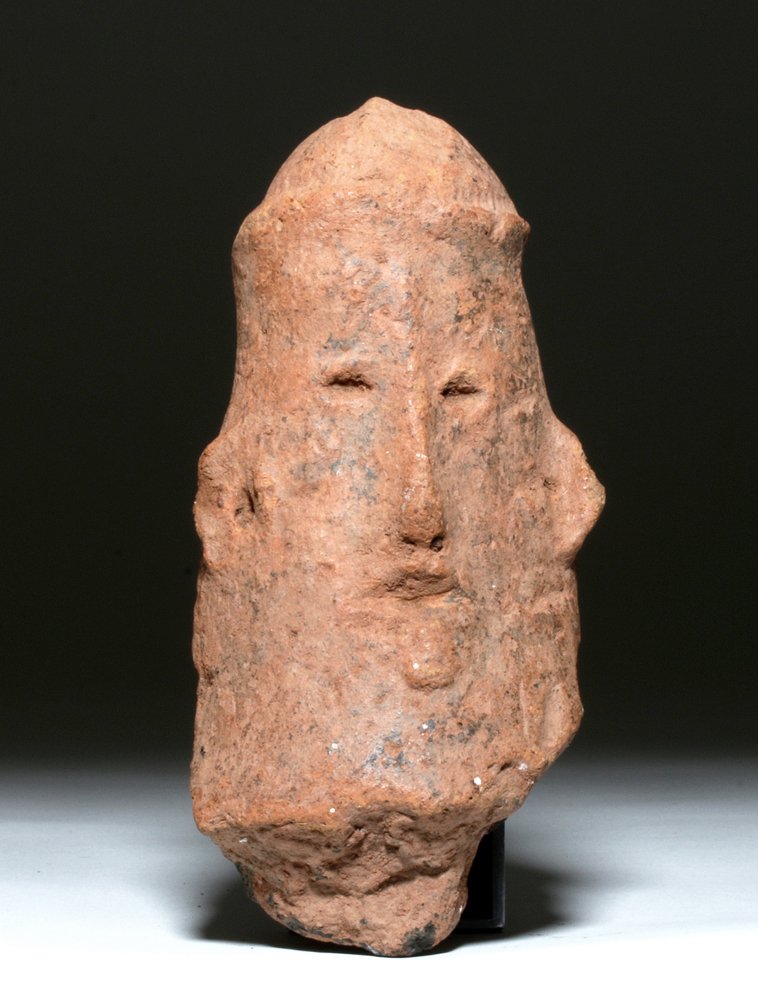 Ancient Nok Terracotta Effigy Head, ex-Arnovick: Africa, Nigeria, Katsina style, ca. 200 BCE to 100 CE. This is a terracotta head with long features and no chin; the eyes are holes, as are the nose and mouth; the ears have been pierced and the figur