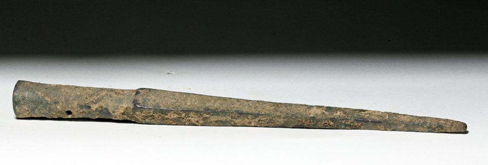 Luristan Bronze Spear Butt, ex-Piscopo: Luristan, modern day Iran, ca. 1000 to 600 BCE. This is a long, thin bronze spear butt in the shape of a very elongated pyramid; the bottom is a socket with a small hole drilled through it. This would