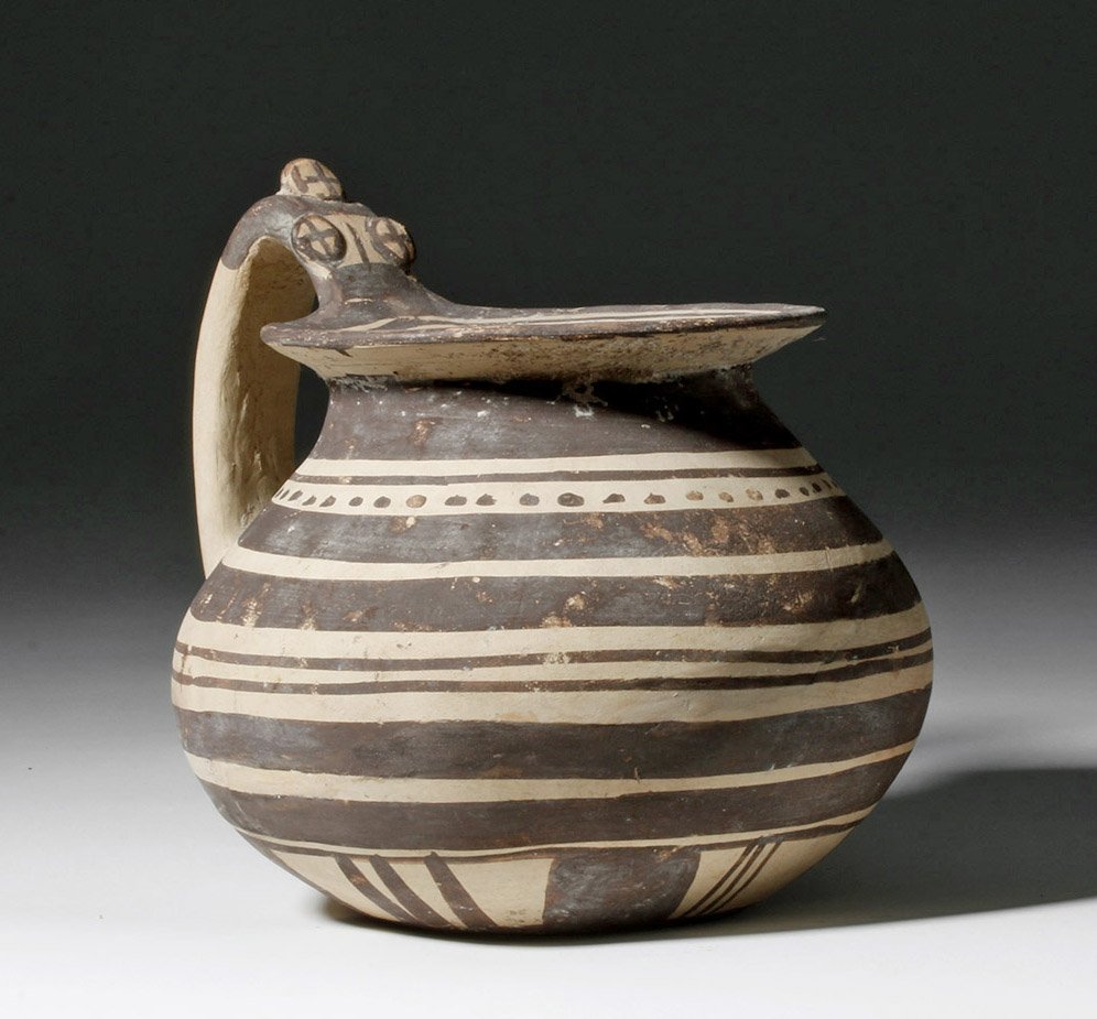 Greek Daunian Single-Handled Pouring Vessel: Italy, Apulia / Daunian, ca. 300 BCE. Daunian society was a mixture of native Italians and Greeks who had settled in the area, with their pottery influenced by both cultures. This is a pleasantly plum